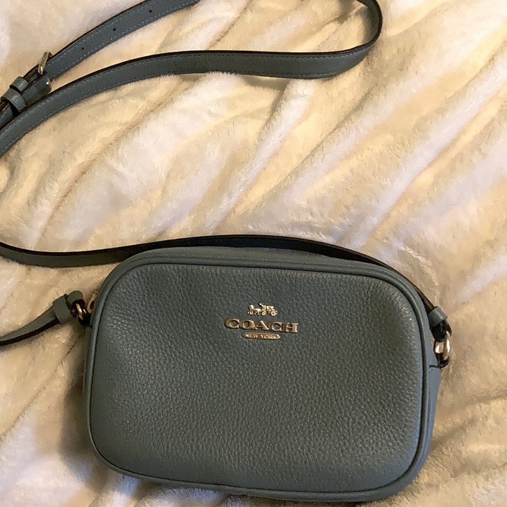 A Coach camera case. Blue with black fabric interior.